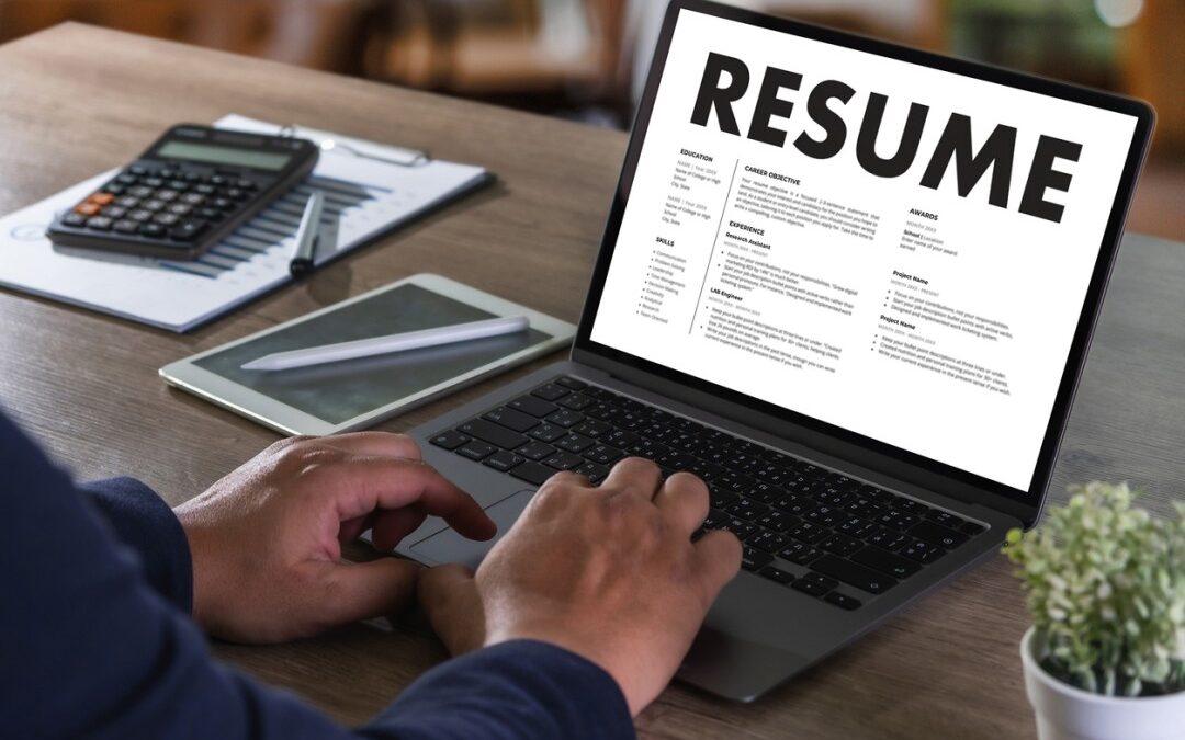 White hands of a man updating his resume.